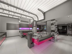 Modern hotel lobby with a pink and grey marble counter, chairs, and clean lines