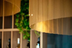 Warm and inviting dining area with a wooden table and chairs, wine bottles, and a cozy atmosphere