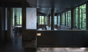 A dining area with a large window, multiple chairs, and a central dining table, creating an inviting and comfortable space