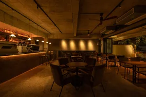 Inviting restaurant interior with a bar and dining tables, chairs, and a relaxed atmosphere
