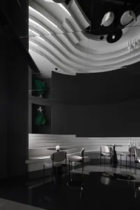 Elegant dining space with multiple tables and chairs, white table tops, and a clean modern atmosphere