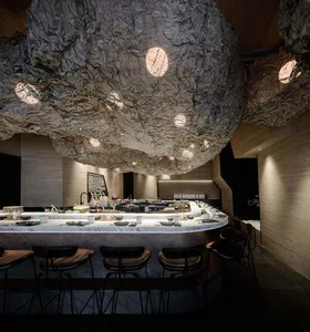 Cozy restaurant dining area with a large wooden table and chairs, well-lit and inviting atmosphere