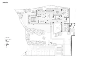 A modern floor plan featuring open areas and smaller rooms with concrete floors and walls, showcasing a clean and minimalistic design