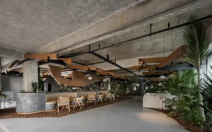 Inviting living area with wooden floors, ceiling beams, and potted plants, suitable for social gatherings or relaxation