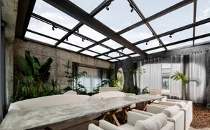 A cozy living area with a large wooden dining table surrounded by chairs, potted plants, and comfortable seating for guests