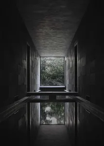 Indoor pool area with stone walls, two benches, and a luxurious atmosphere