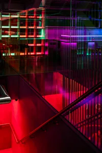 A modern glass staircase in a vibrant and visually appealing art gallery setting