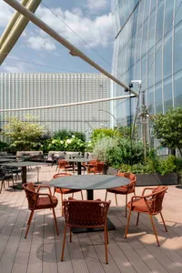 A modern dining space with multiple tables and chairs, designed for social gatherings and events, featuring a modern and inviting atmosphere