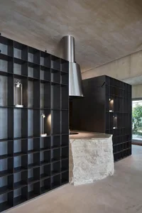Modern kitchen with a stone countertop island, black theme, and sleek appearance