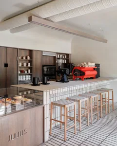 Industrial-style restaurant kitchen with stainless steel appliances, wooden accents, and a variety of kitchen items