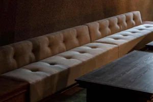 A cozy living space with two couches arranged in a semi-circle around a dining table, creating an inviting atmosphere for relaxation and socializing