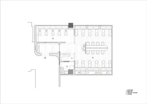 Empty lobby with white walls, minimalist seating areas, and a clean atmosphere
