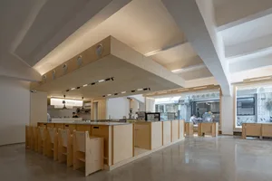 Warm and inviting kitchen with wooden cabinets and countertops, a dining table, and chairs