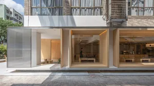 Open living area with a large window, two chairs, and a dining table, featuring a bright and spacious atmosphere