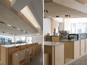 Warm and inviting restaurant interior with wooden walls and ceiling, featuring multiple tables and chairs in a comfortable dining area
