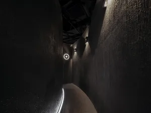 Black and white hallway with two lights on either side, creating a calm and inviting atmosphere