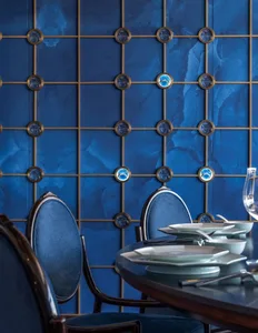 Dining area with a table and chairs, surrounded by a unique circular wall design, with plates on the table suggesting recent use
