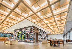 Cozy bookstore interior with wooden floors and ceiling, lined with bookshelves and filled with books