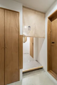 Bathroom with wooden cabinets, brown finish, two doors, and a shower curtain for privacy