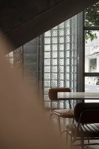 A modern dining space with a glass table surrounded by chairs, creating a contemporary atmosphere