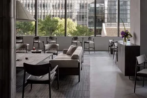 Comfortable living space with a large couch, multiple chairs, and a dining table, creating a welcoming atmosphere for relaxation and socialization