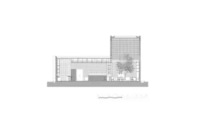 A modern house with a white exterior, multiple windows, and two chairs in a well-designed living space
