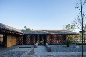 Asian-style house with a wooden exterior, featuring a large roof, a mix of open spaces and enclosed rooms, and a blend of traditional and modern elements