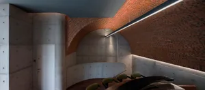 A dimly lit contemporary building with a concrete spiral staircase, clean lines, and minimalistic elements