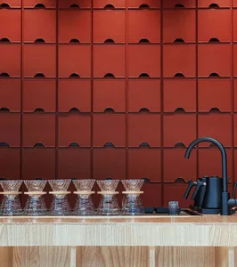Warm and inviting kitchen space with wooden countertops, cabinets, and a sink, featuring several cups on the counter