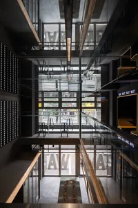 Spacious modern space with glass walls, chairs, and natural light