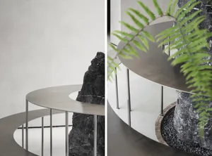 A modern living space with two large rocks and a potted plant, featuring clean lines and minimalistic design elements