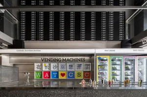 A modern Asian restaurant with vending machines and refrigerators on display, featuring a clean and organized atmosphere with a focus on refreshments