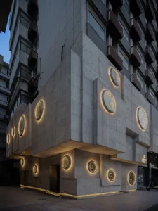 Modern building with circular windows, illuminated by round lights, made of concrete in a contemporary urban setting