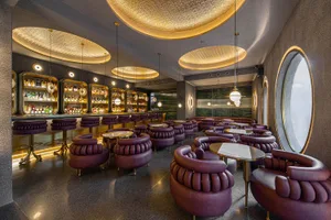 優雅餐廳內部，紫色座椅與桌椅、舒適座位區，以及多種風格混搭