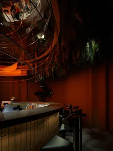 A bar area with a counter and chairs, creating a relaxed and inviting atmosphere for socializing and enjoying drinks