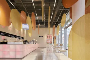 A clean and bright interior design showroom with white walls, tables, and chairs, creating a welcoming atmosphere for visitors to explore various designs and styles