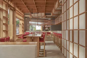 Warm and inviting restaurant interior with wooden walls, ceiling beams, and modern-traditional design elements