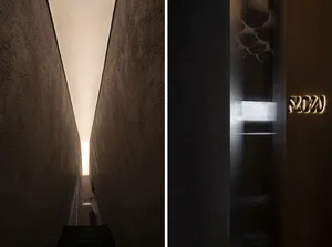 Industrial hallways with concrete walls, a staircase, and a door, giving a sense of depth and perspective
