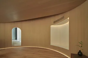 Empty room with wooden walls and floors, giving a clean and minimalist appearance