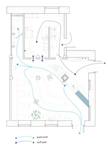 2D floor plan of a modern hotel with various rooms connected by hallways and staircases, featuring a mix of open and enclosed areas