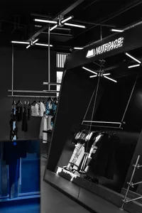 Well-lit store display featuring dresses on racks, with a focus on showcasing available clothing items