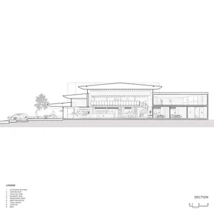 A modern hotel or residential complex with a circular structure featuring multiple levels, glass, and steel, exuding luxury and sophistication