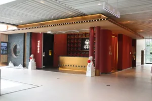 Inviting hotel lobby with a bar, chairs, and potted plants creating a warm and comfortable atmosphere