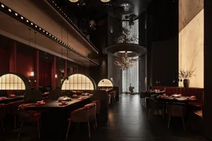 A modern restaurant with a large dining area featuring multiple tables and chairs, set with bowls, creating an inviting and comfortable atmosphere for socializing and dining