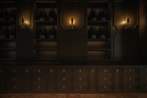 A dark room with an old black cabinet and multiple bottles on various surfaces