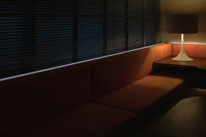 Cozy living area with a leather couch and natural light from a nearby window