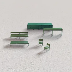 A white room with green furniture, including a large green table and several chairs of different sizes, and three benches arranged to create an inviting atmosphere