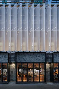 A modern building with large glass windows, allowing natural light to illuminate the interior spaces