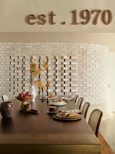 A warm and inviting dining space with a wooden table, chairs, and a breakfast setting