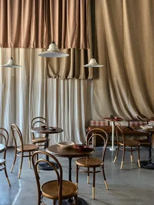 Modern restaurant interior with wooden tables and chairs, creating a warm and inviting atmosphere